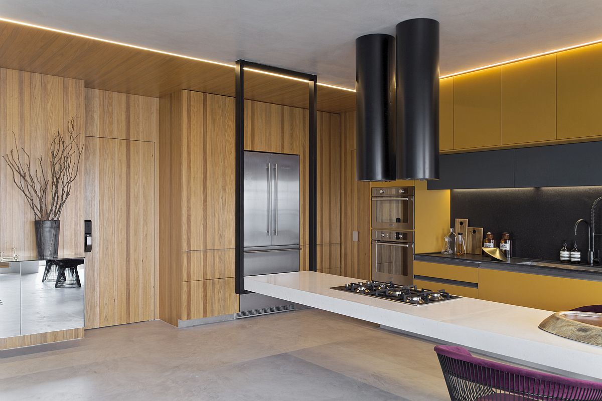 Curated wall of Tauari wood adds warmth to the polished contemporary kitchen