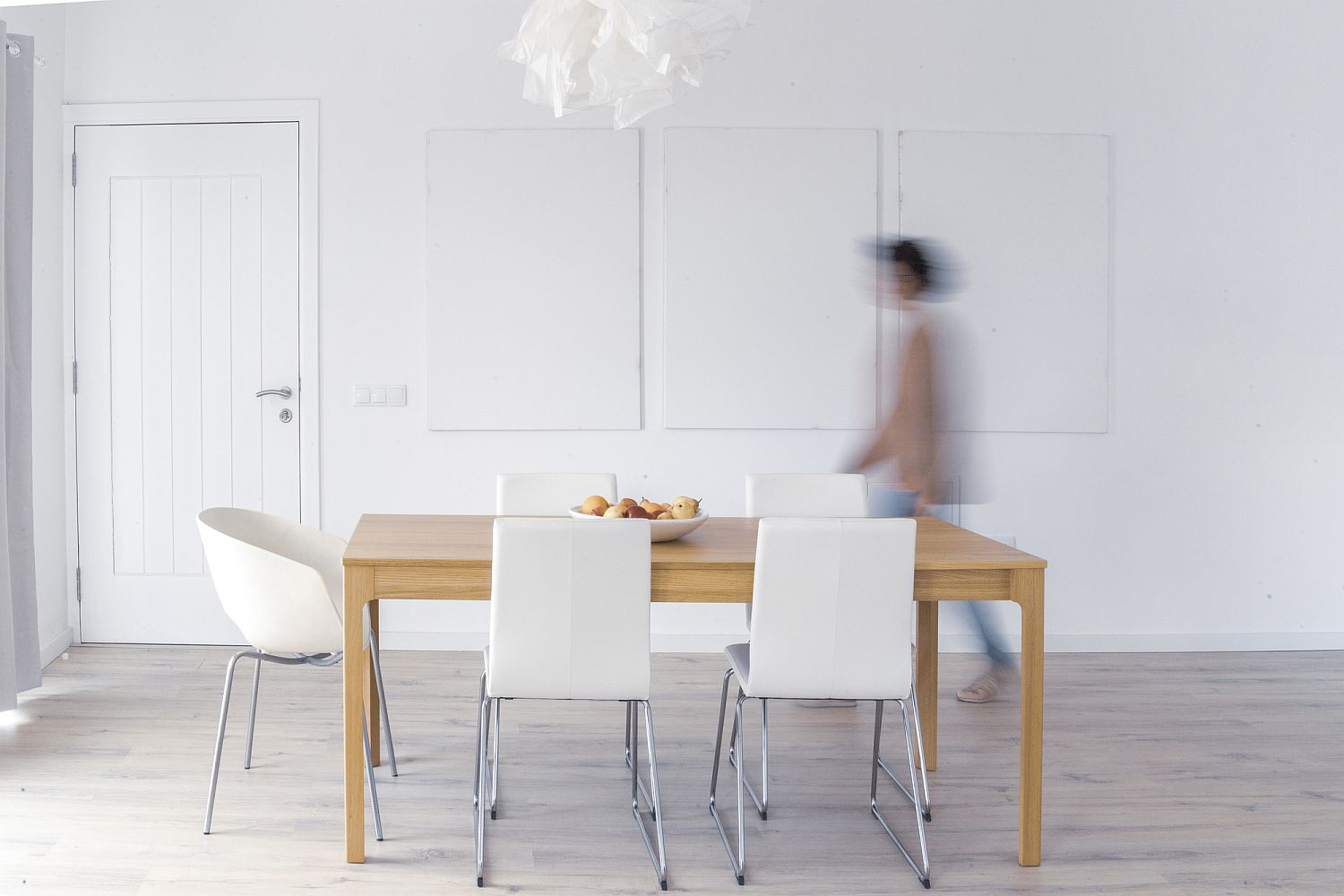 Dining room in white with wooden dining table