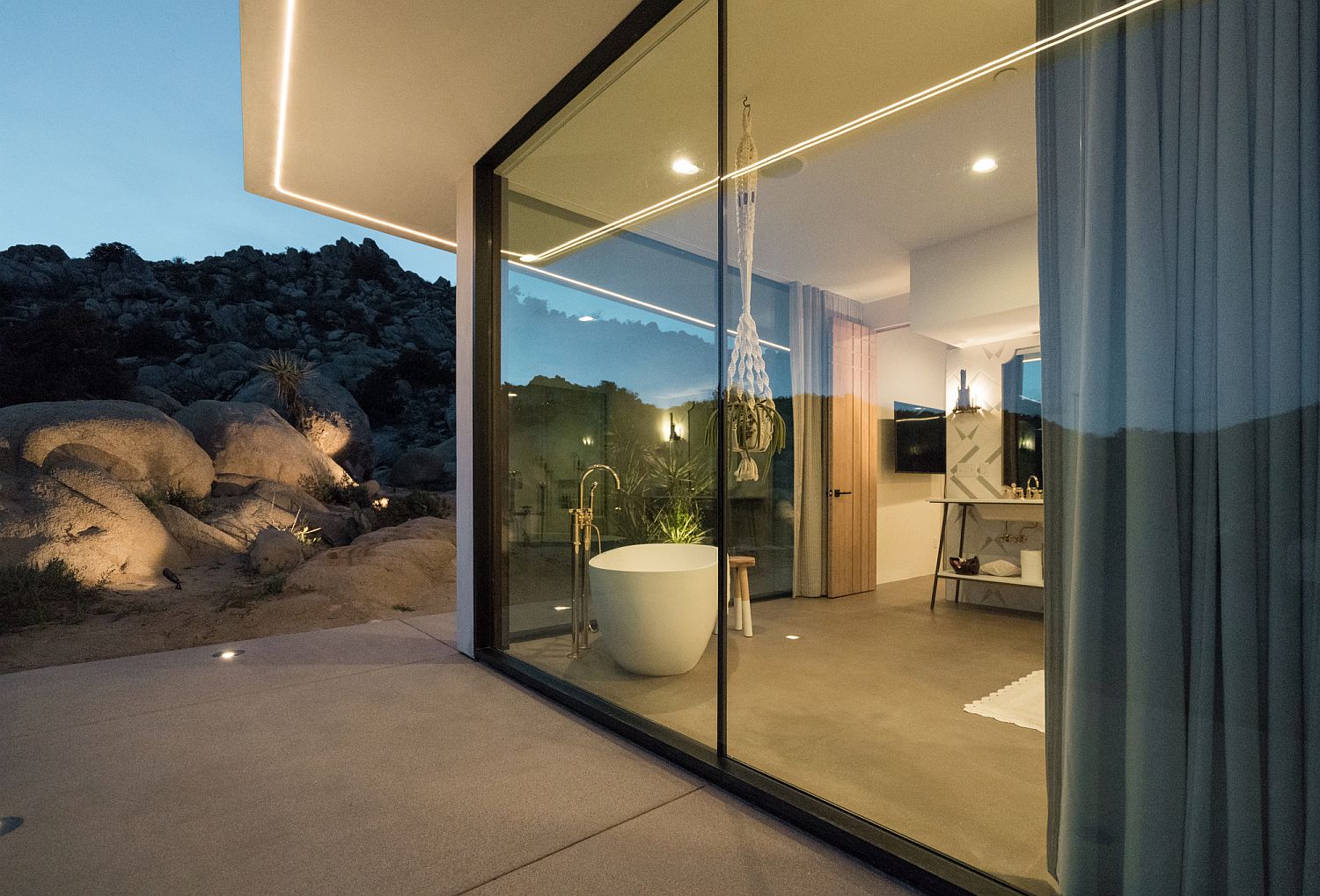 Floor-to-ceiling glass walls open up the interior to the view outside