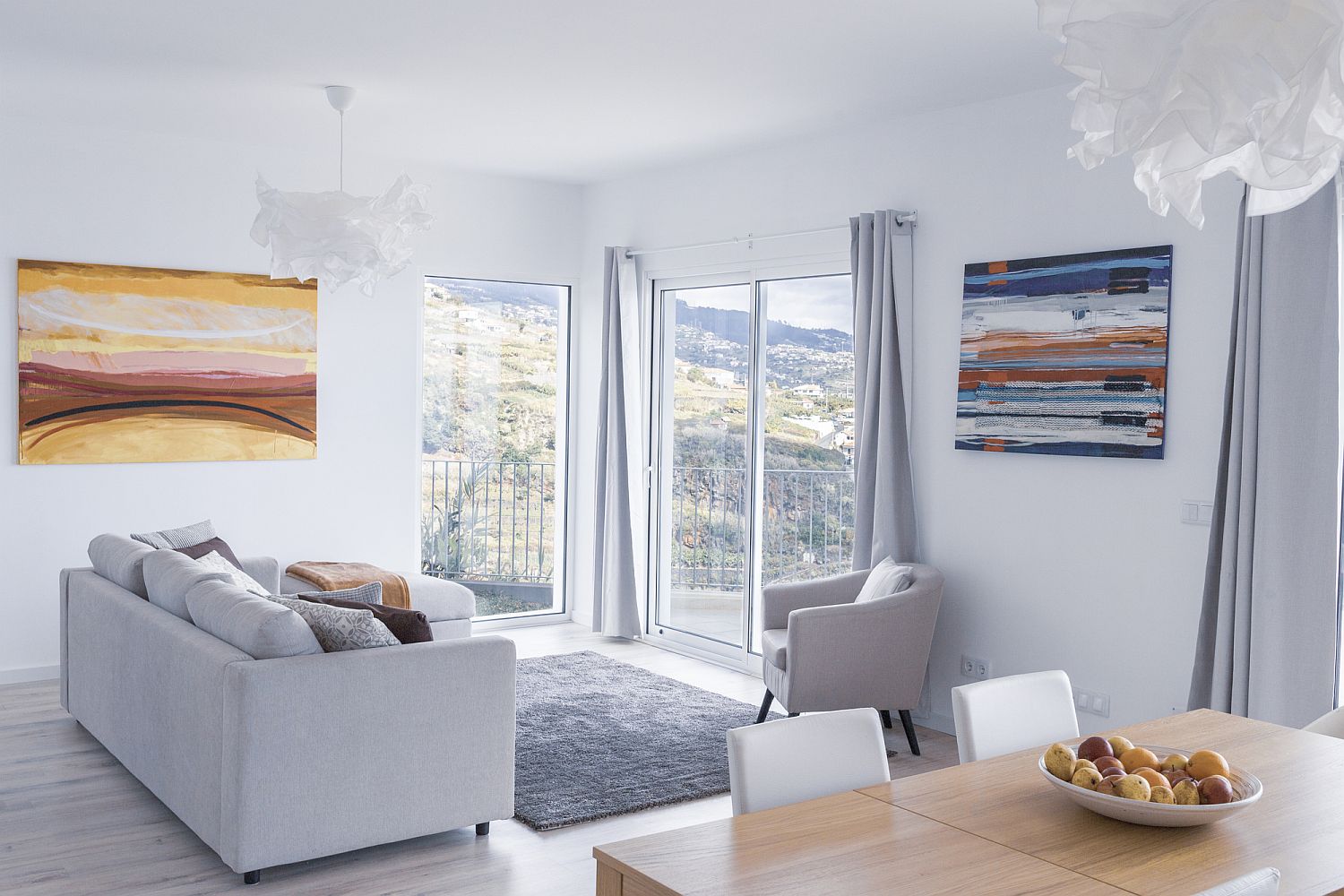 Paintings add color to the white living room