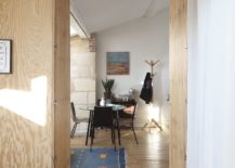 Unfinsihed-wooden-surfaces-add-a-bit-of-rustic-warmth-to-the-modern-apartment-in-white-217x155