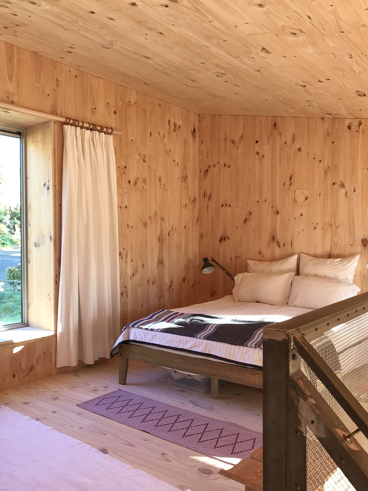 Upper level bedroom of the cabin with cozy modern appeal