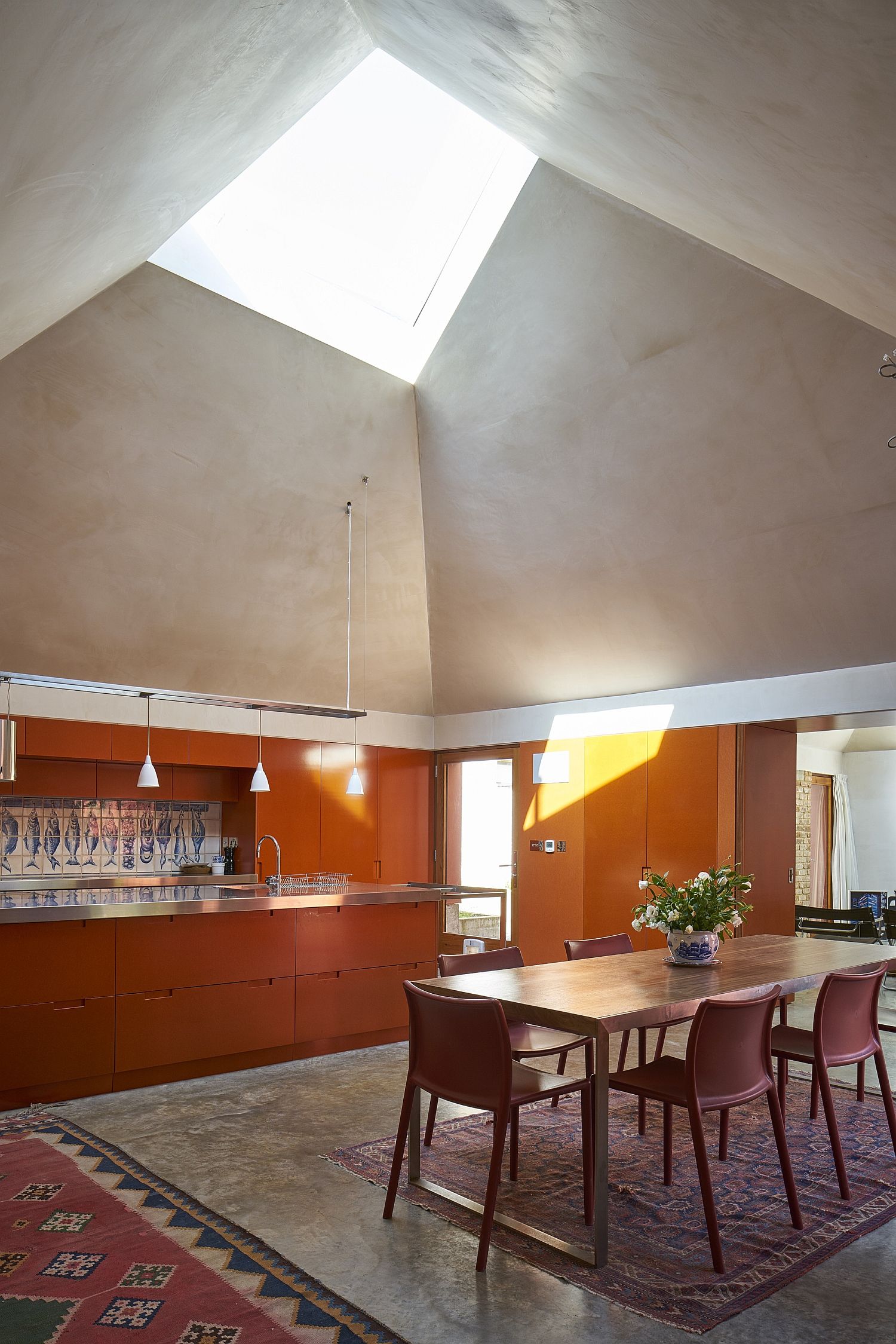 Awesome ceiling design and skylight steal the show in this orangy home