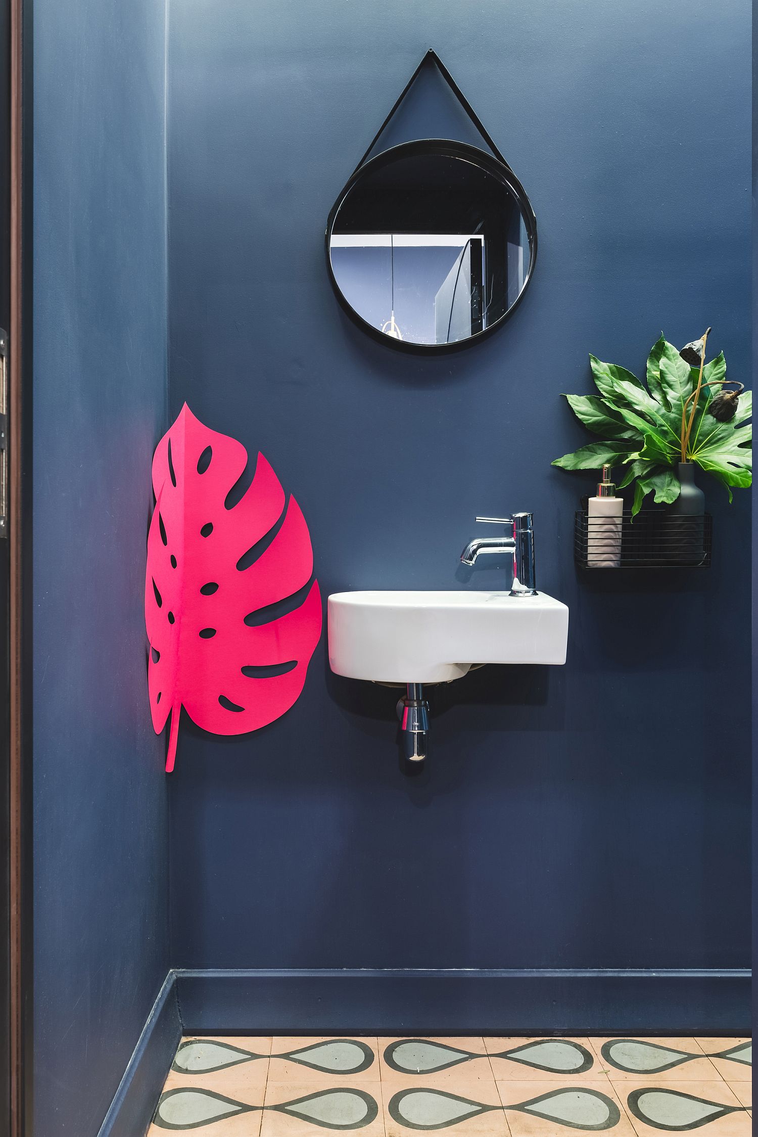 Bathrooms inside the cafe in brilliant blue and bright pink leaf motif