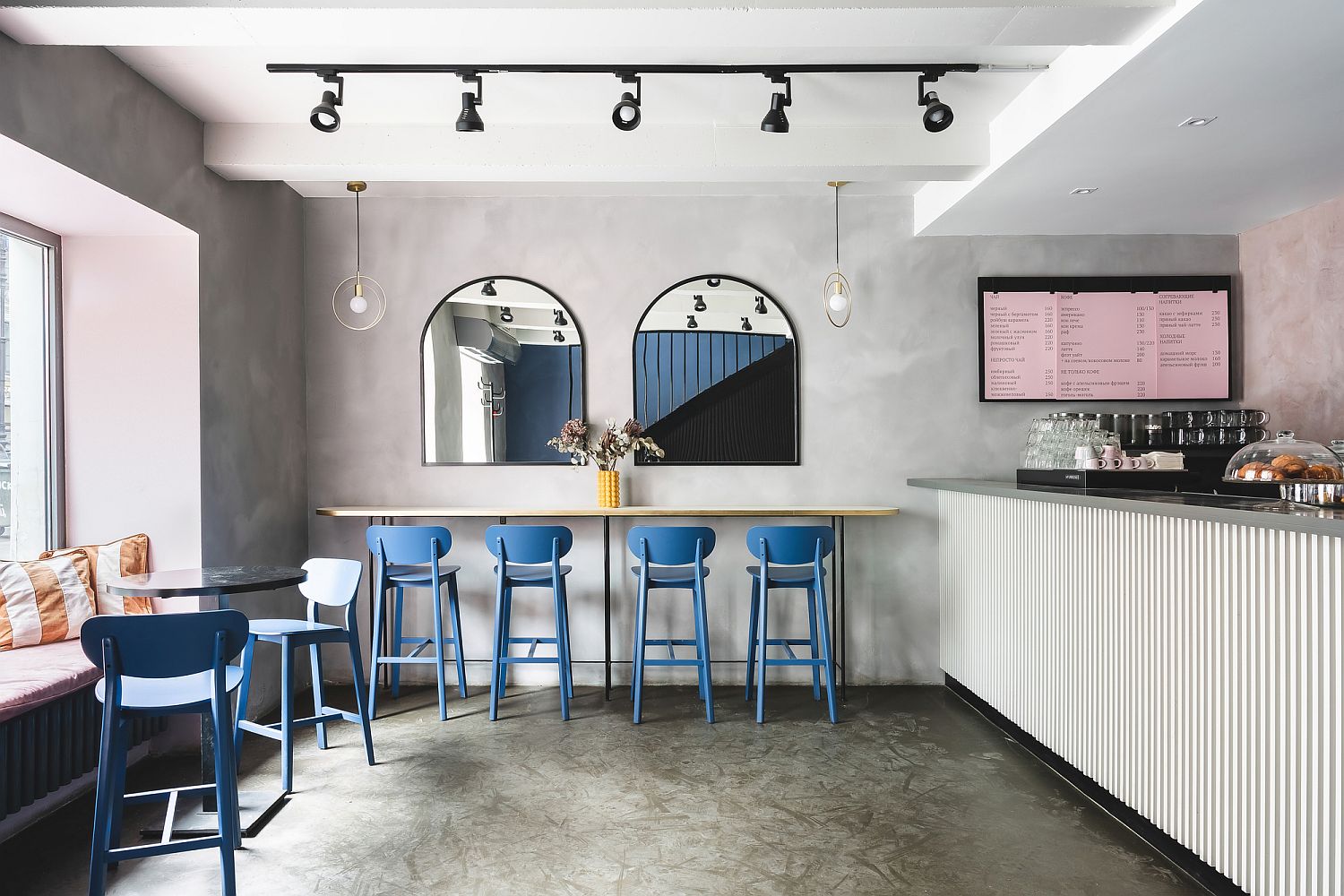 Blue, pinks and raw concrete combined inside the Russian cafe