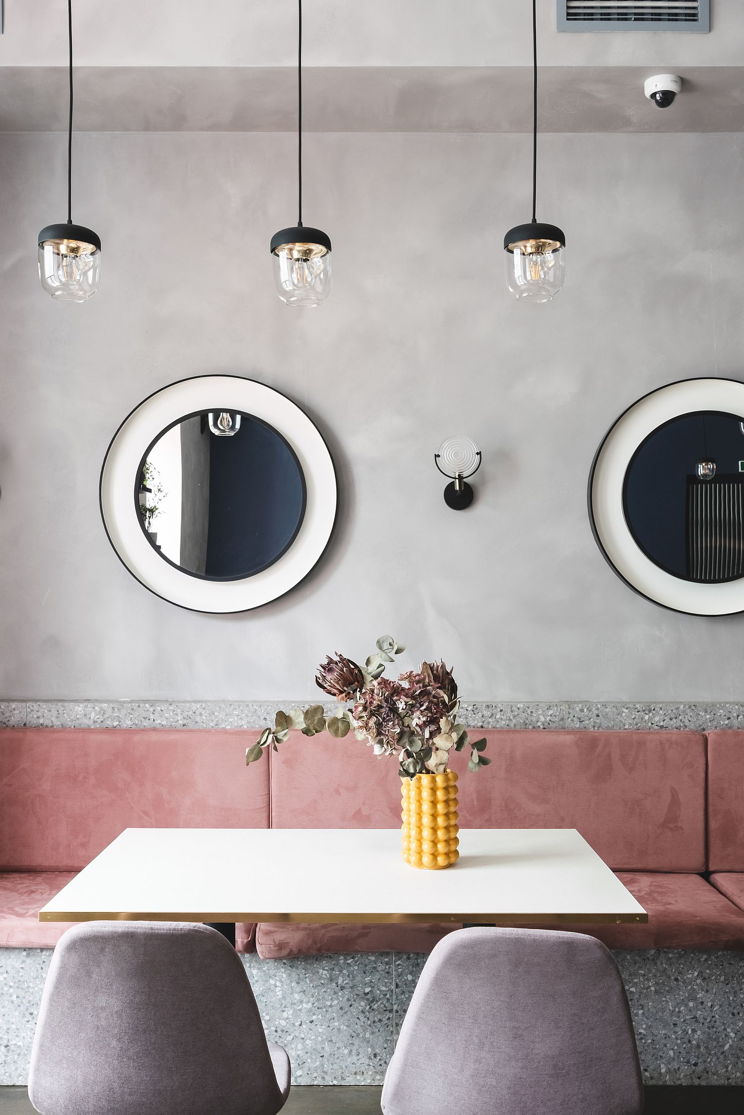 Circular windows along with smart lighting inside the Russian cafe