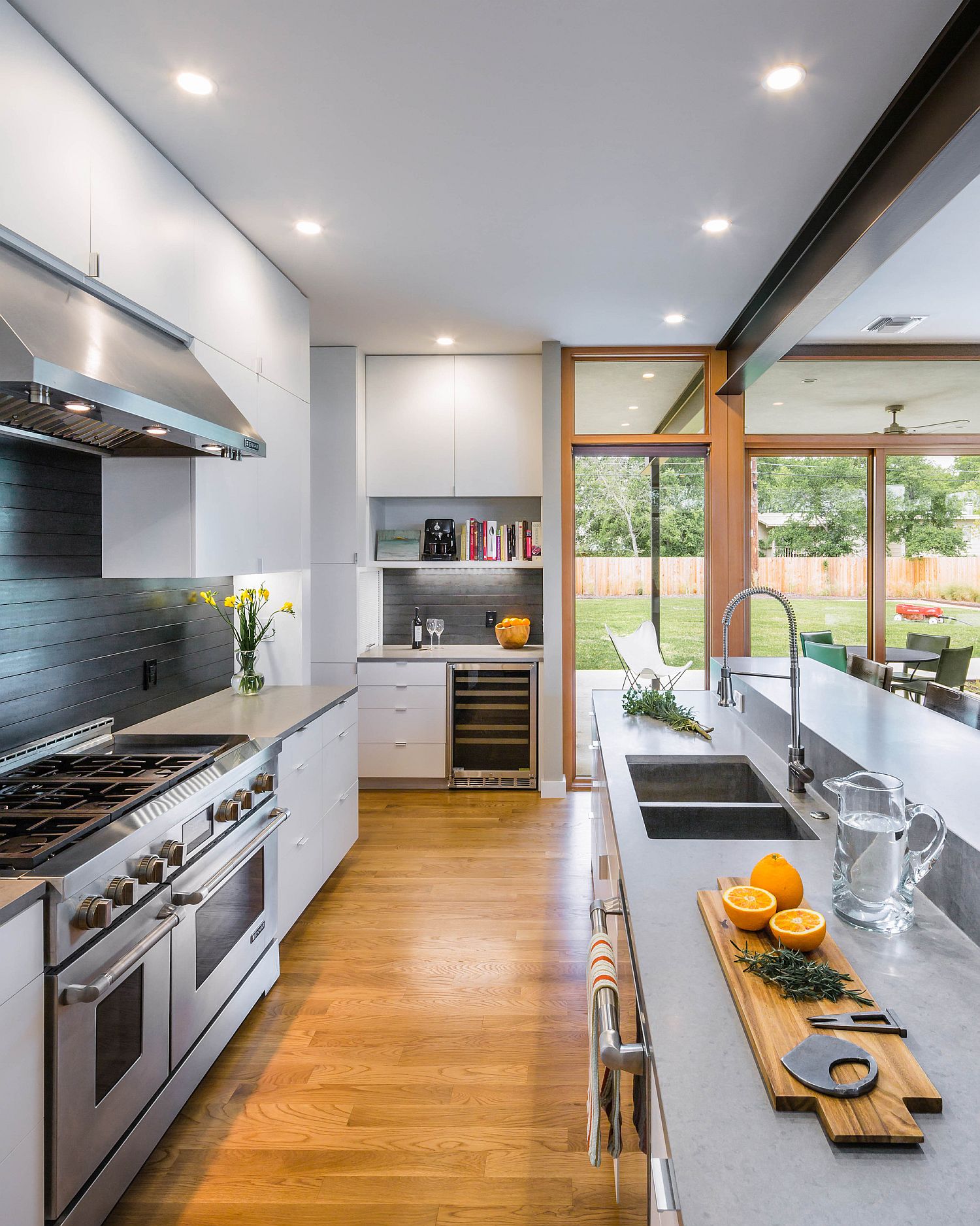 Contemporary kitchen with multiple islands and flooring in wood