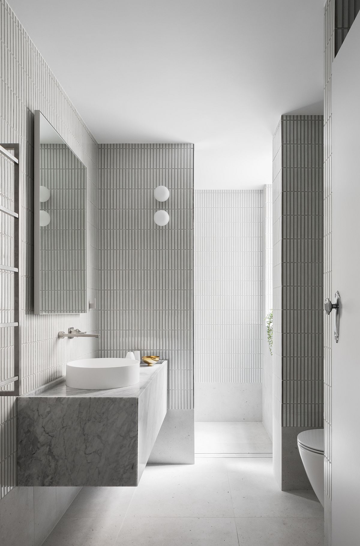 Gray and white bathroom with ample natural lighting