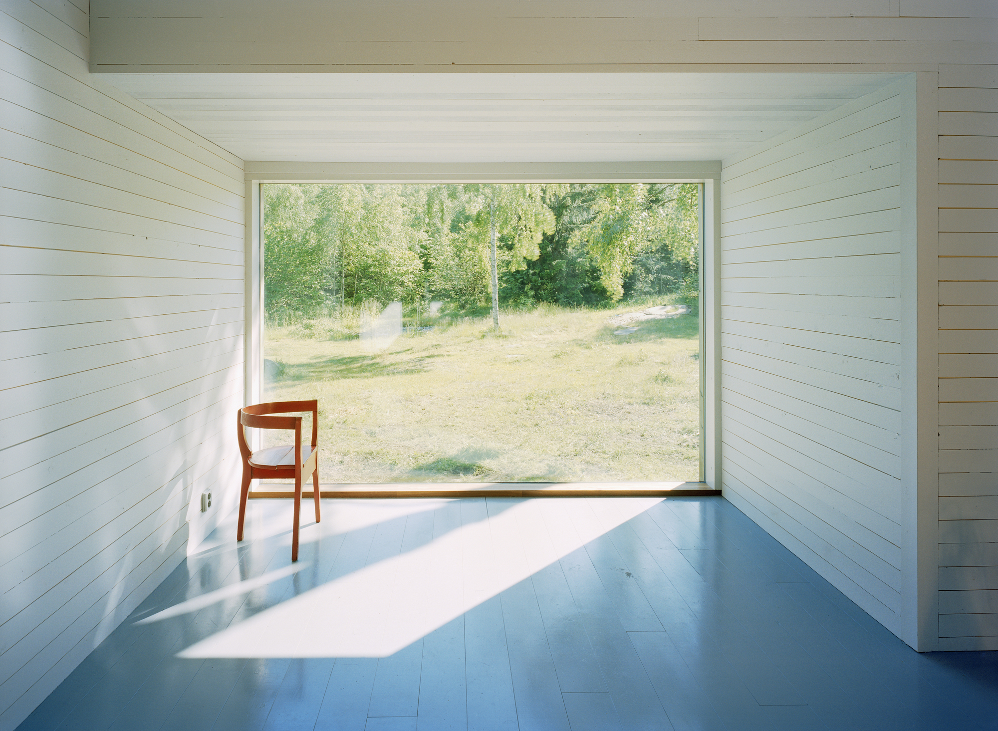 Large floor-to-ceiling window brings the outdoors inside and frames the views