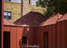Multiple-pavilions-in-orange-metal-create-a-cool-courtyard-within-217x155
