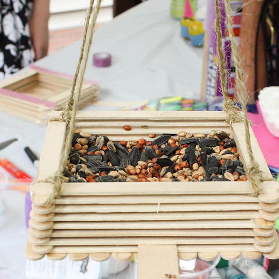 Smart little bird feeder made using craft sticks and glue