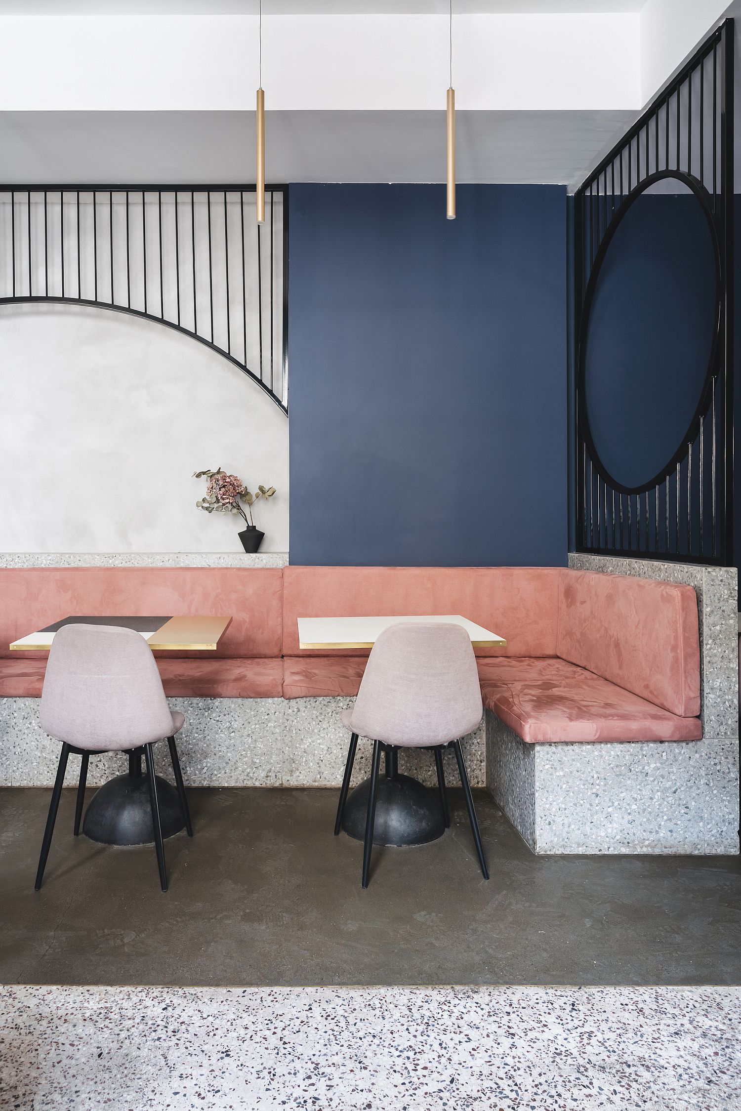 Soft pastel pinks and blues are coupled with exposed concrete inside the apartment