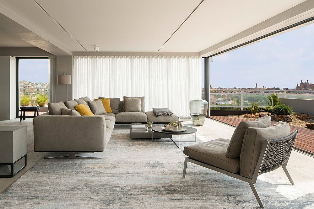 Spacious living room that flows into the deck features a large gray sectional