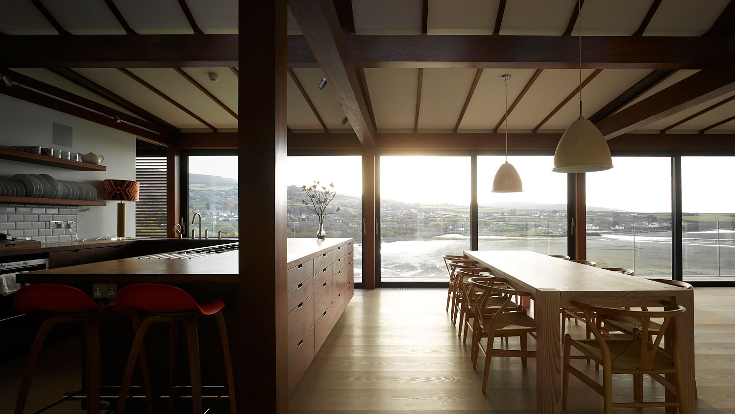 Wooden beams shape the ceiling in the kitchen and dining area
