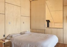 Bedroom-feels-much-more-cozier-thanks-to-the-wooden-panels-on-walls-217x155