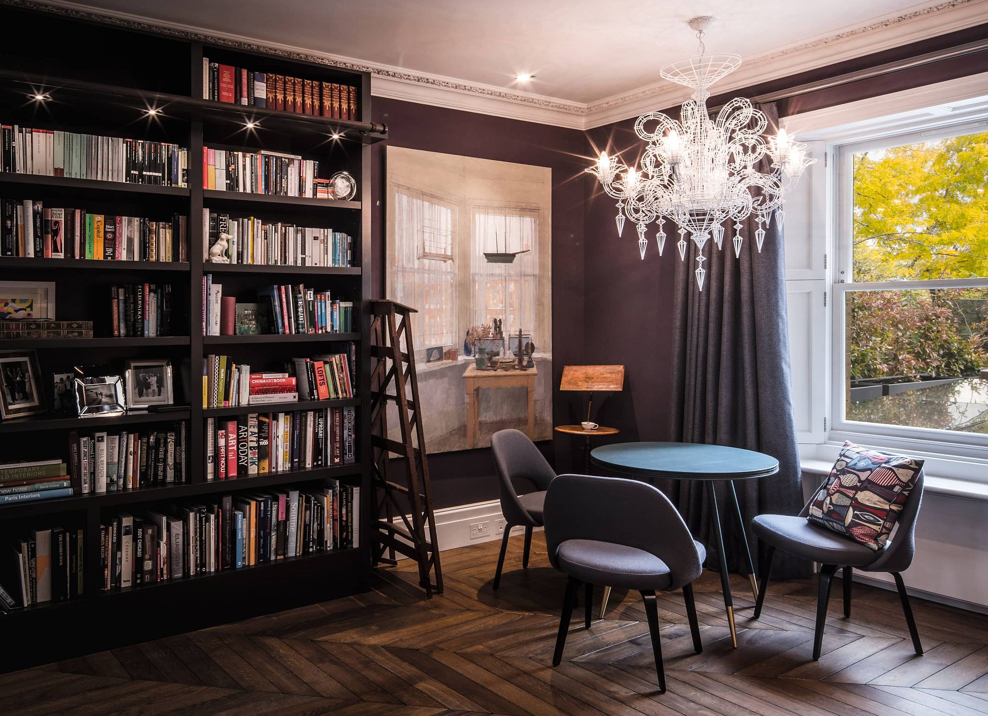 Black walls and a spacious bookshelf give the room a classic eclectic vibe