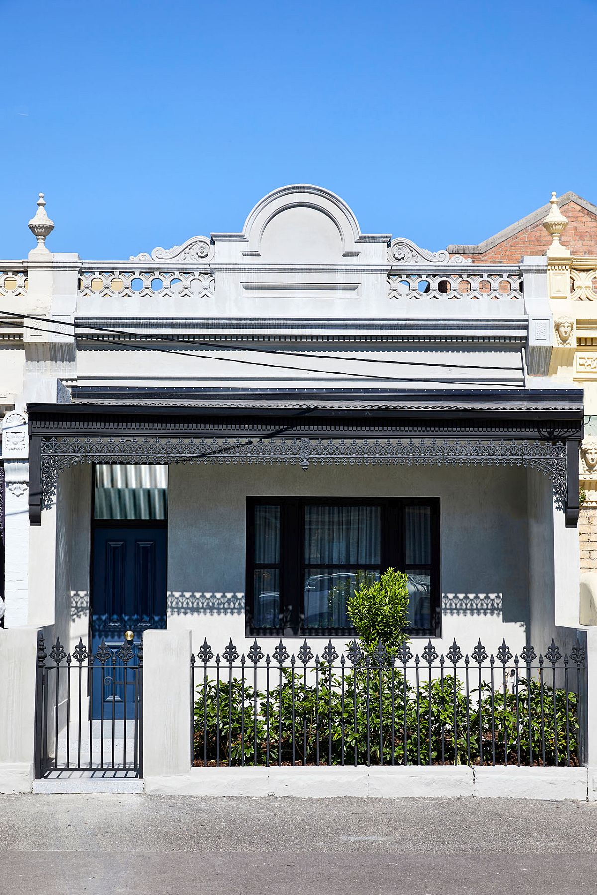 Classic street facade of the Victorian style Melbourne home with Italianate-style terrace