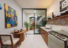 Colorful-tiled-backsplash-and-art-piece-bring-Mexican-flavor-to-the-kitchen-217x155