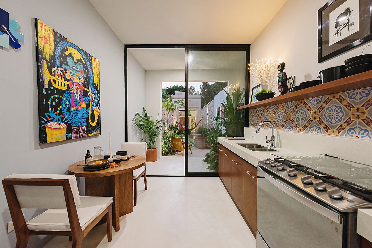 Colorful tiled backsplash and art piece bring Mexican flavor to the kitchen