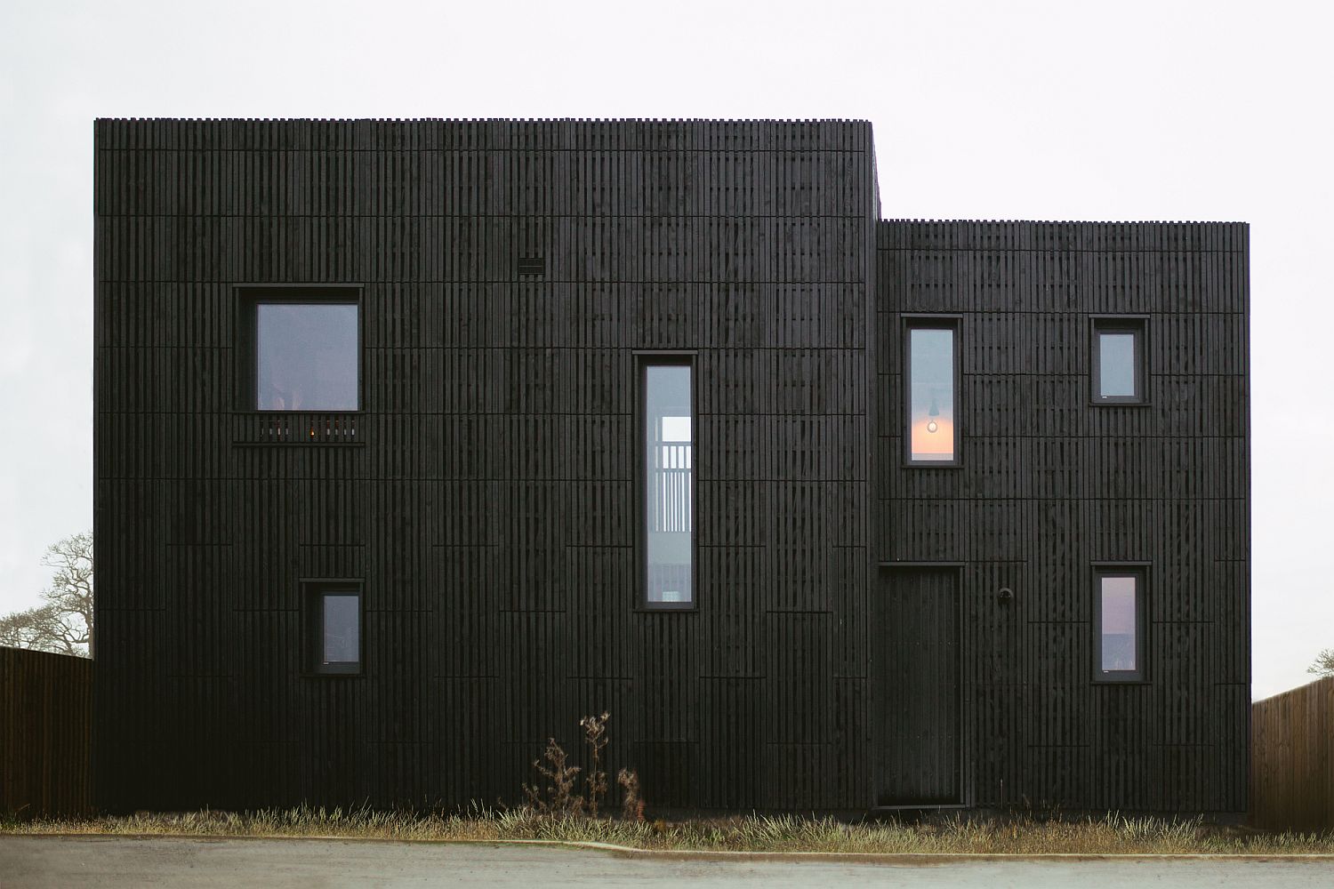 Dark, box-shaped exterior of the house in Bicester