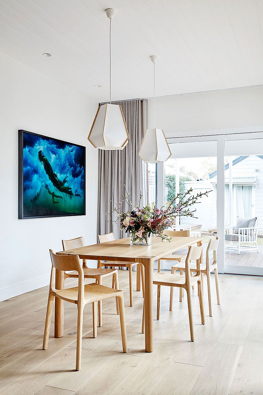 Dashing dining table and chairs in wood along with geometric pendants