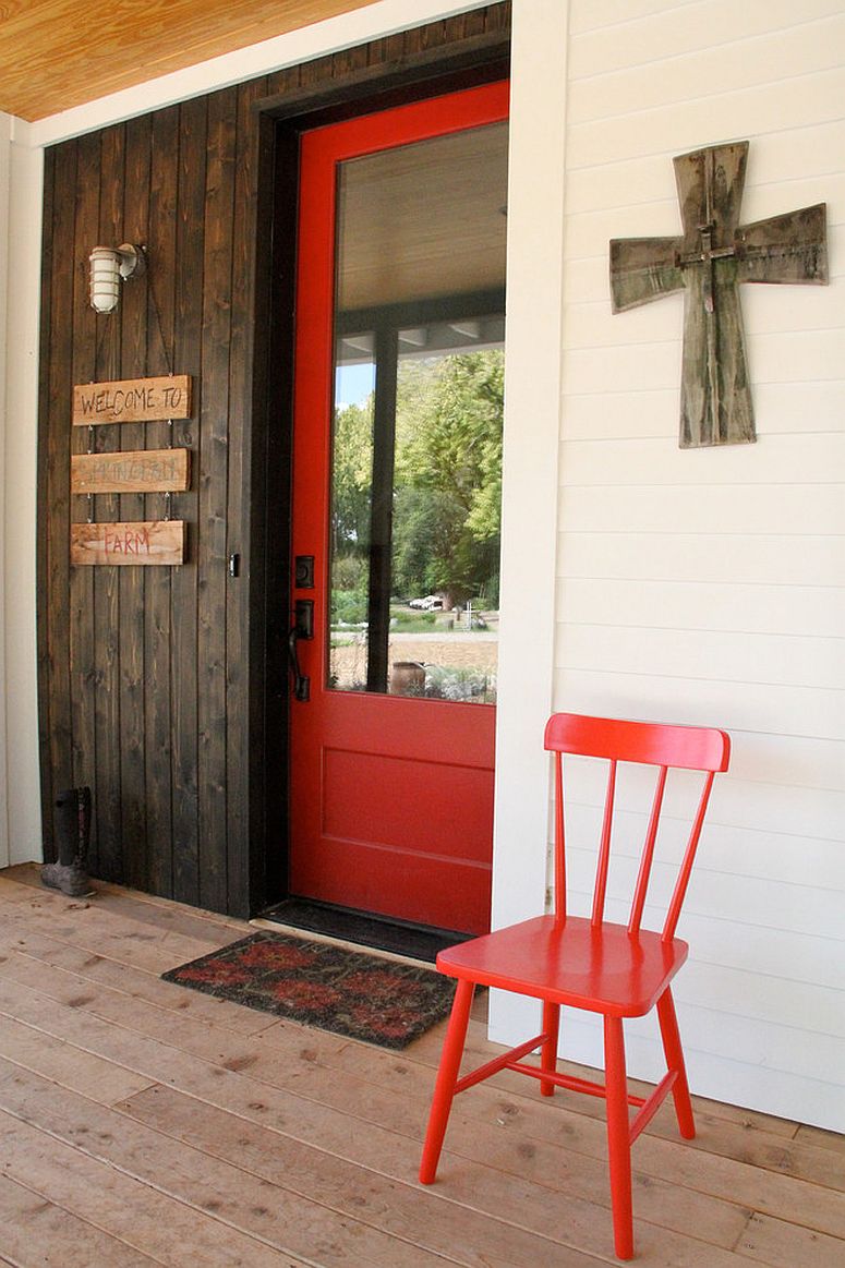 Entry-door-in-wood-and-glass-painted-tomato-red-adds-to-the-farmhouse-style-of-this-home