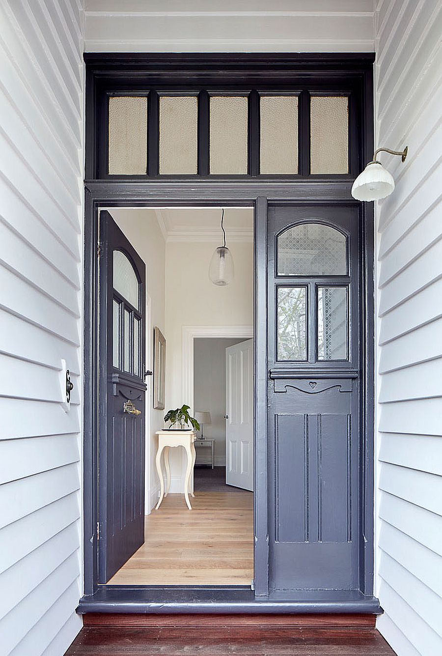 Entry to the traditional home with modern gray doors