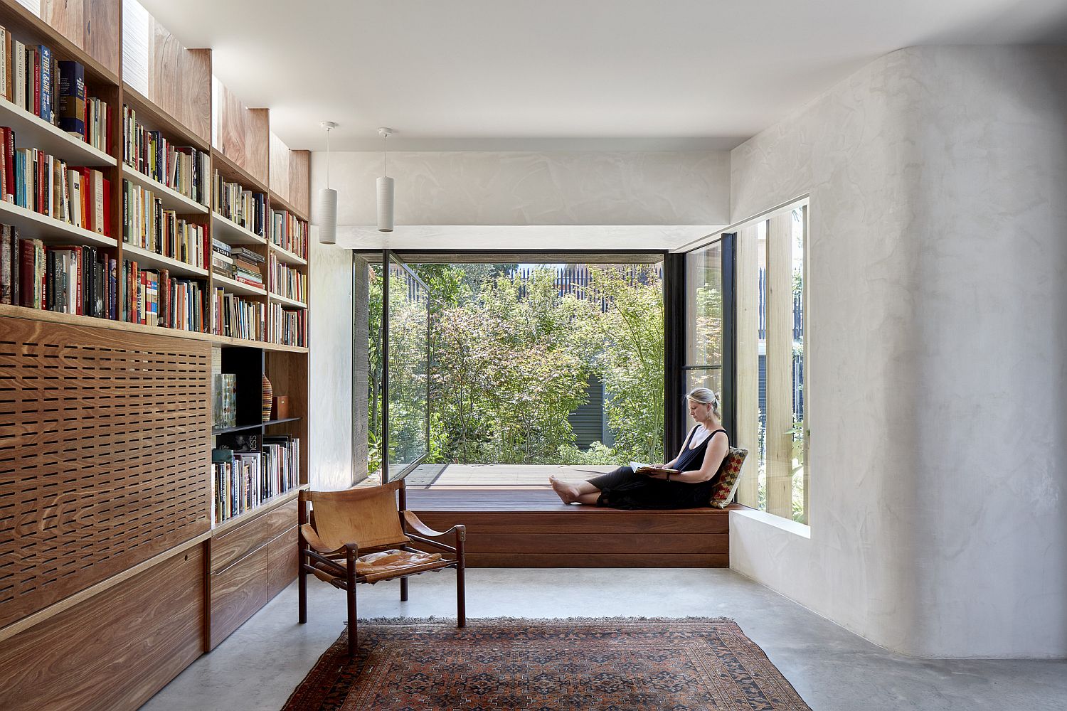 Fabulous little window seat with wall of books on the other side for a relaxing reading area