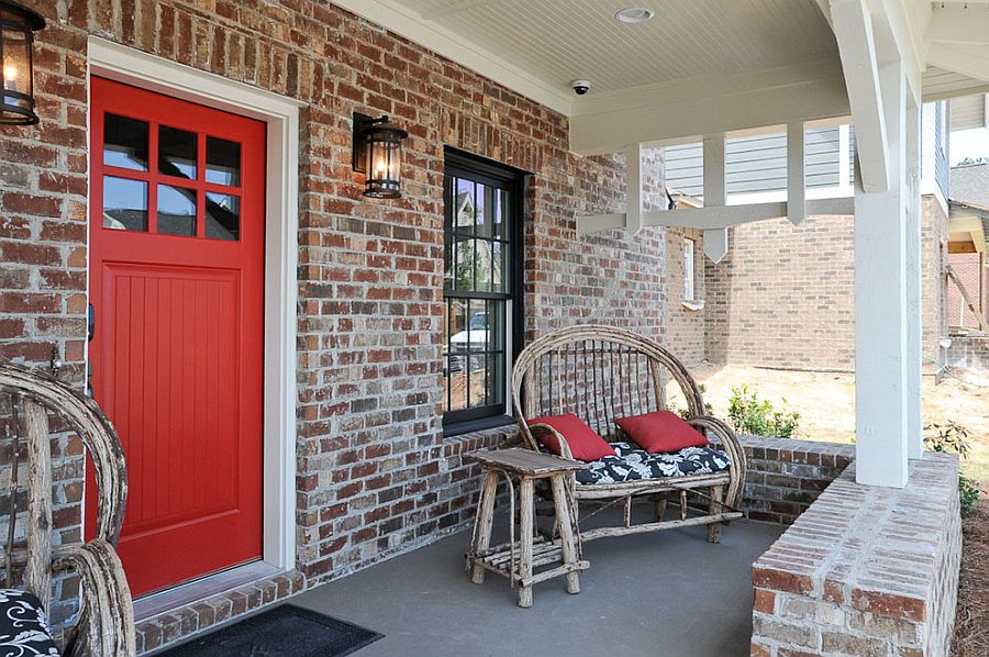 Farmhouse-style-door-in-red-for-a-home-with-exposed-brick-facade