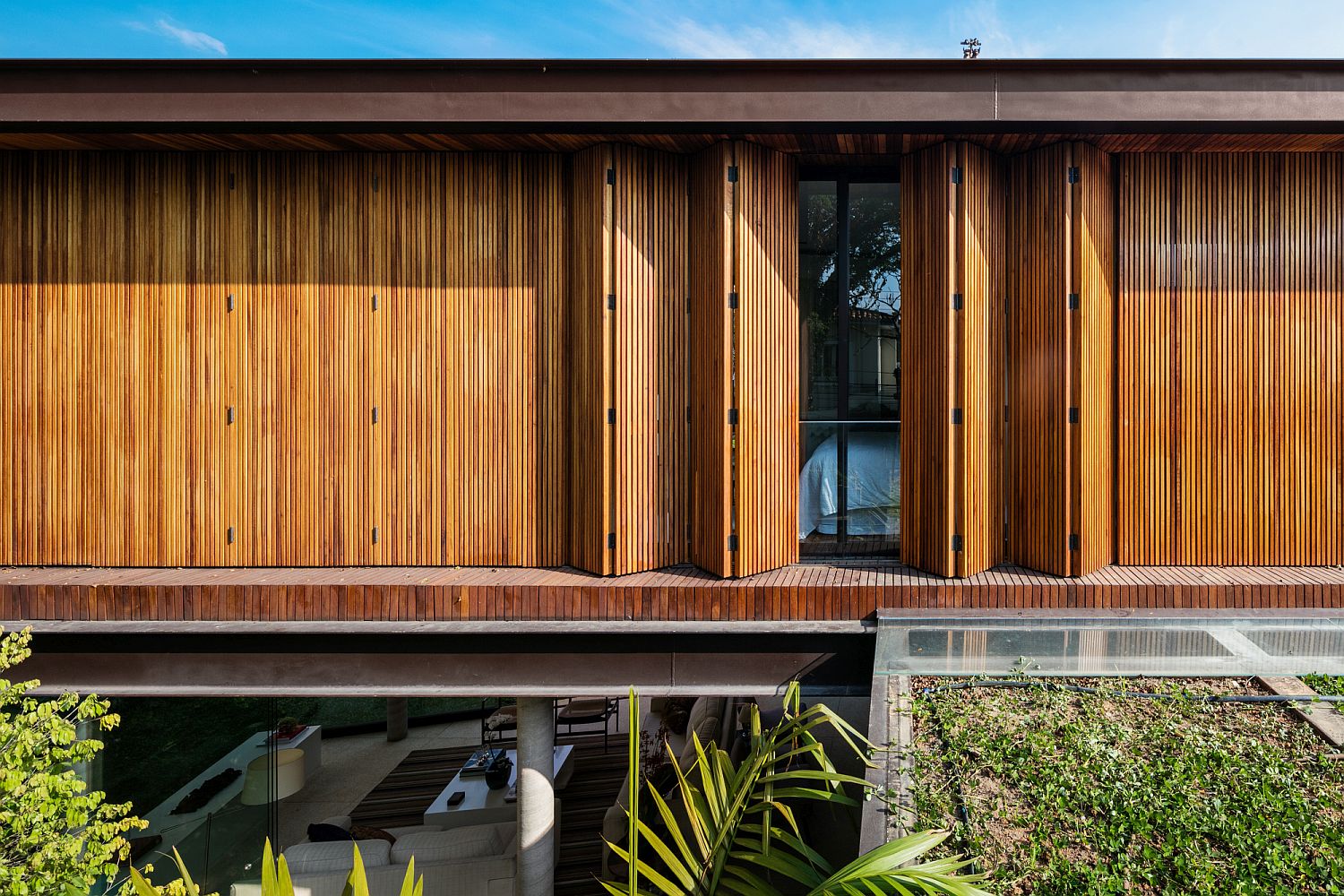 Folding wooden doors allow the homeowners to shift between privacy and lovely views