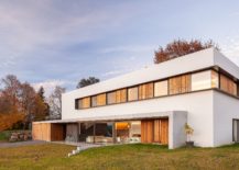 Lovely-blend-of-wood-and-white-shape-the-exterior-of-the-home-in-Olot-217x155