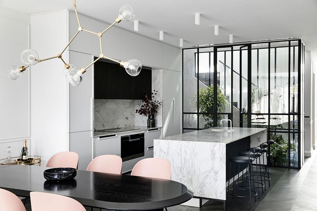 Marble along with metallic pendant fixture brings polished elegance to the interior