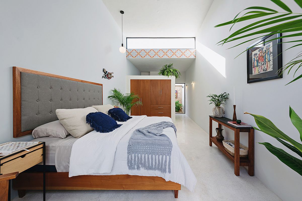 Modern bedroom in white with wooden accents and art work from Pablo Picasso