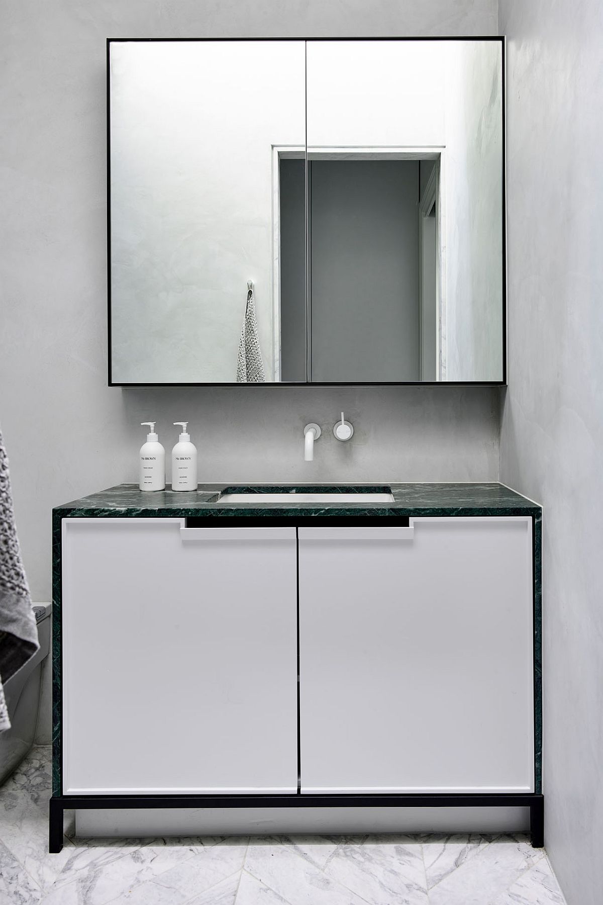 Modern minimal bathroom in white with a slim vanity and stone contertop