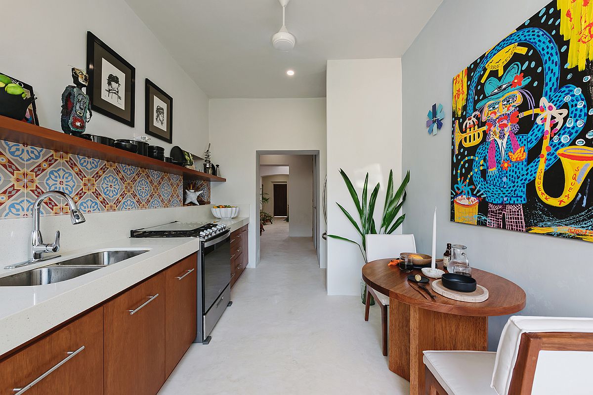 Narrow kitchen and casual breakfast nook in white and wood with a pinch of color