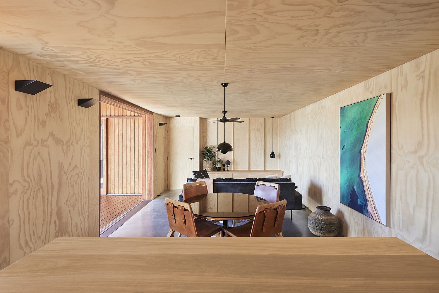 Open living area of the Aussie home with plywood walls