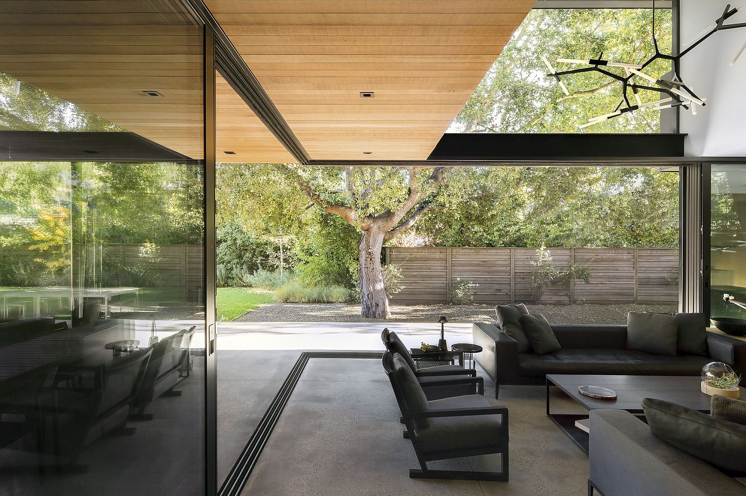 Sliding glass doors connect the living area with the landscape