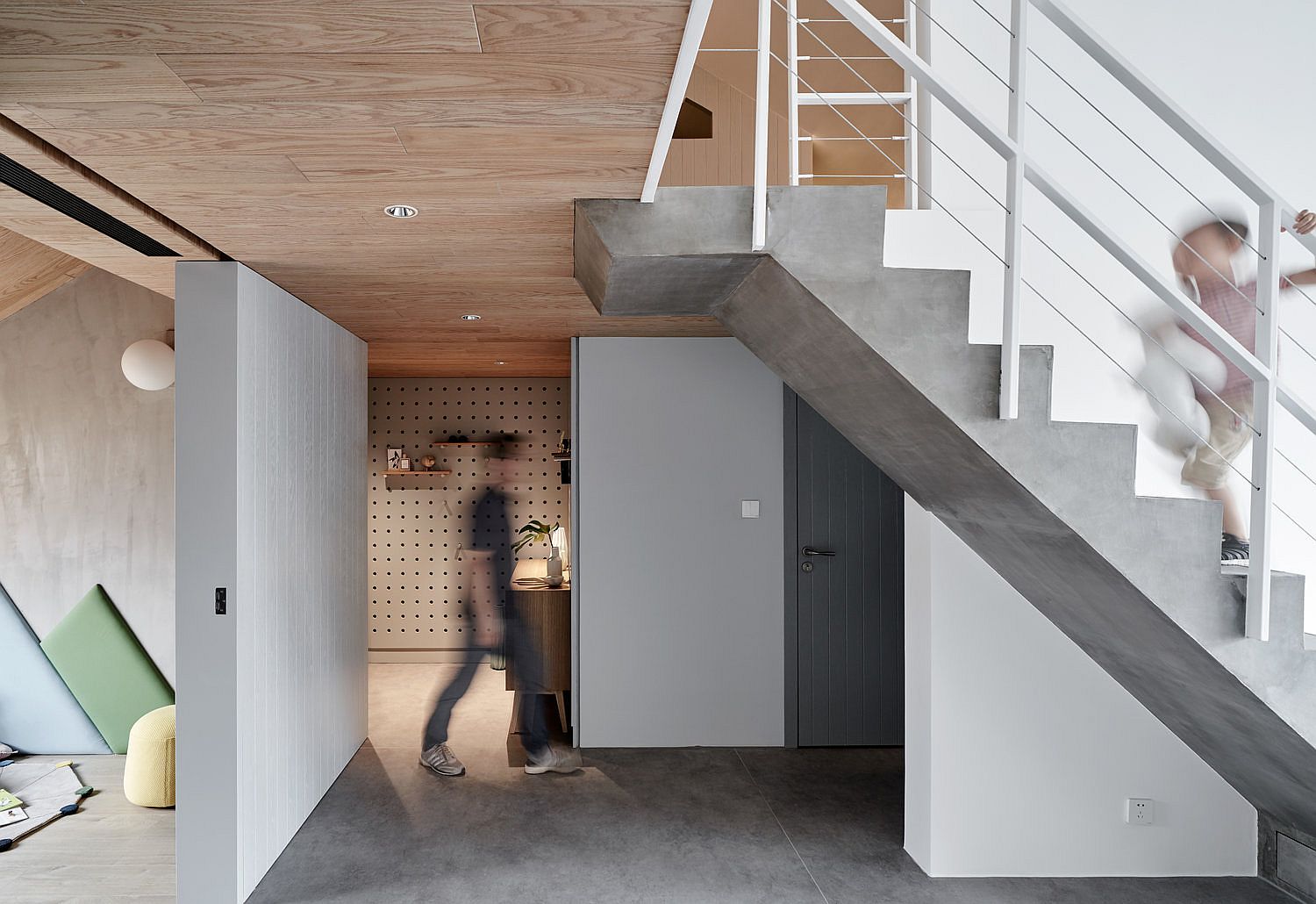 Staircase and floor brings concrete charm to the interior