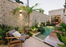 Stone-wall-lush-green-vegetation-and-a-slim-wooden-deck-create-a-private-and-relaxing-pool-zone-217x155