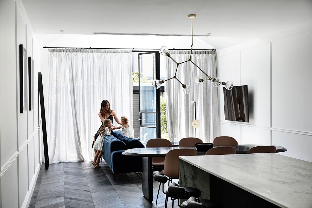 Stylish and minimal living room in white with a bright blue sofa