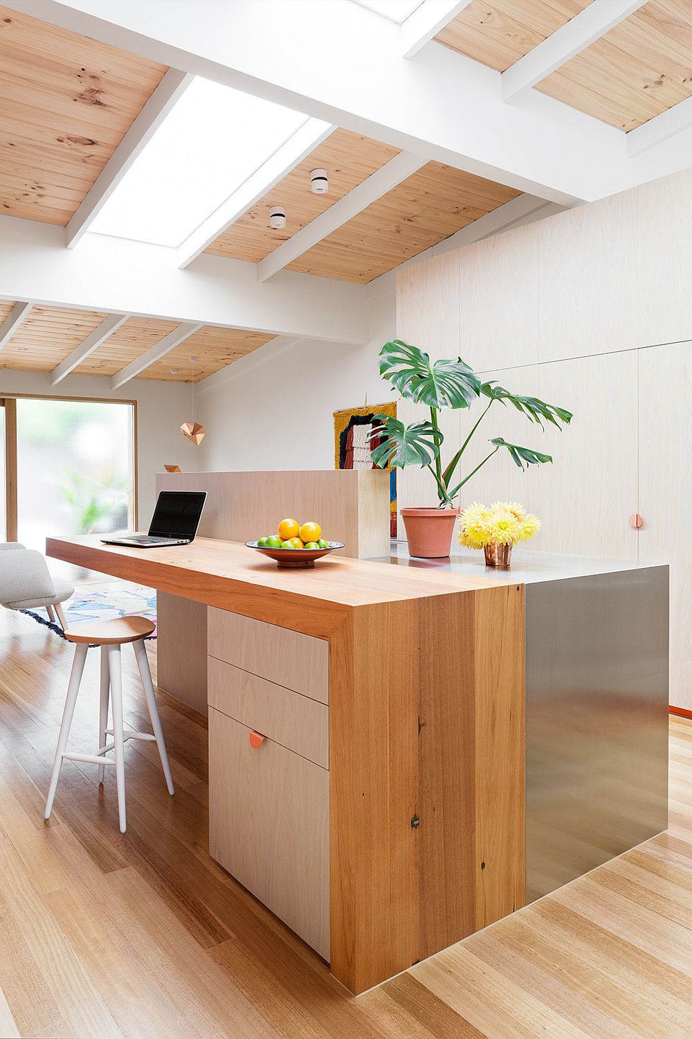 Translucent glass panes bring light into this modest kitchen that also acts as workspace