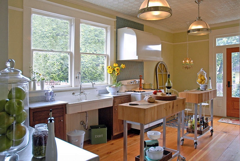 Two narrow, custom-built kitchen islands on wheels are perfect for the small kitchen