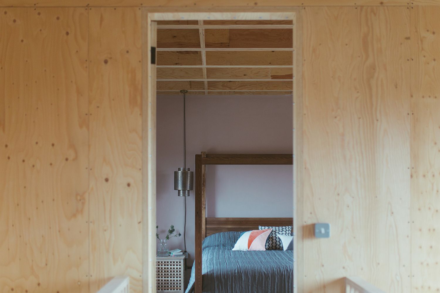 View of the bedroom from outside with walls in wood