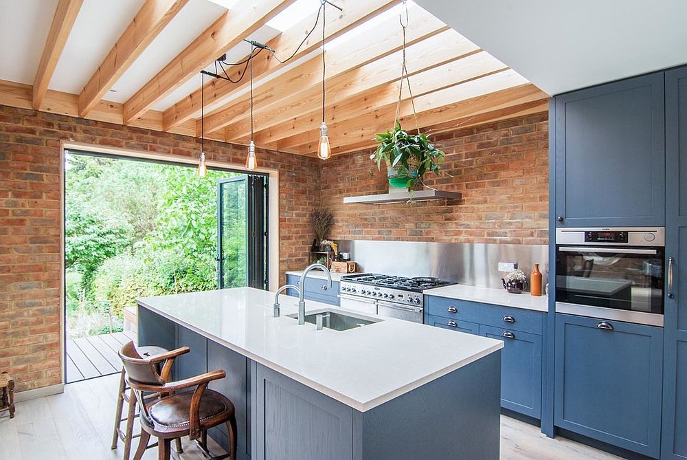 Brick walls make a rare appearance in the becah style kitchen with a hint of white and blue