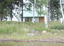 Cabin-in-light-green-on-a-forested-Swedish-island-217x155