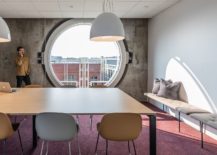 Circular-windows-and-concrete-walls-inside-the-modern-minimal-office-217x155