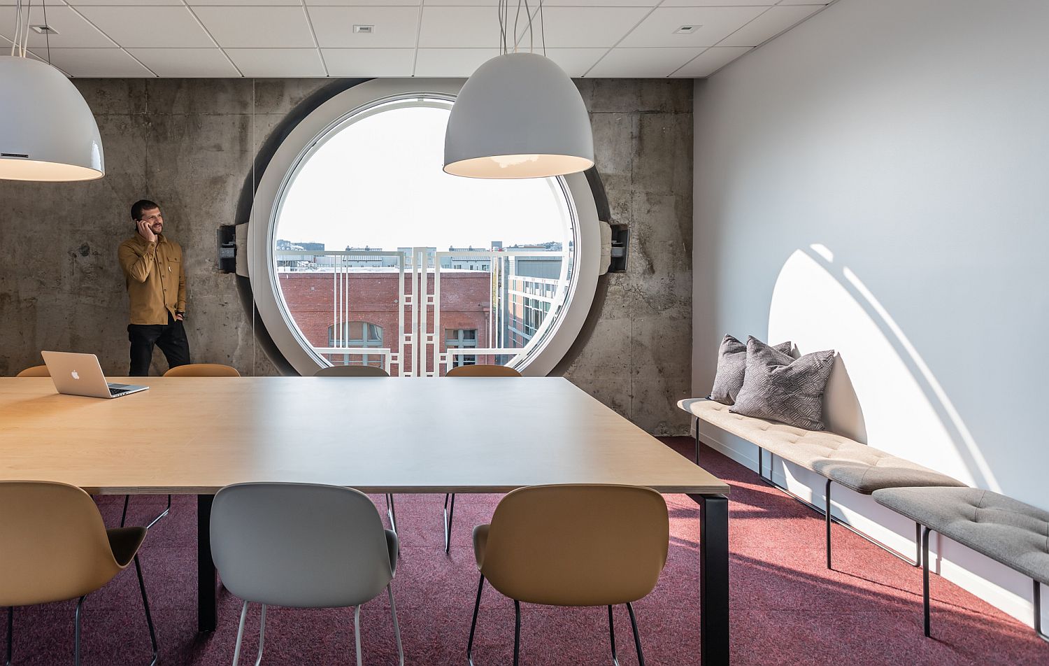 Circular windows and concrete walls inside the modern minimal office