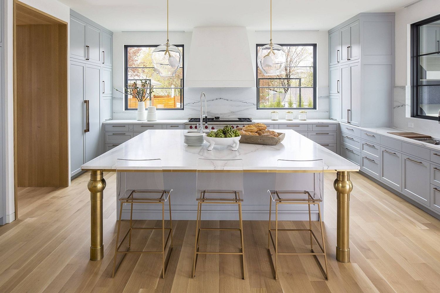 Custom kitchen island in acrylic and brass for the modern white kitchen