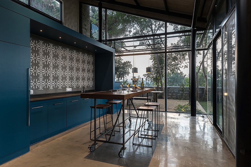 Island on wheels brings modualr charm to this industrial style kitchen with an overload of blue