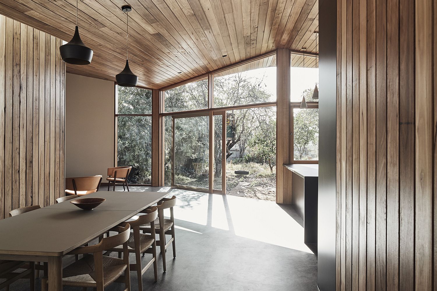 Walls and ceiling draped in wood adds warmth to the interior